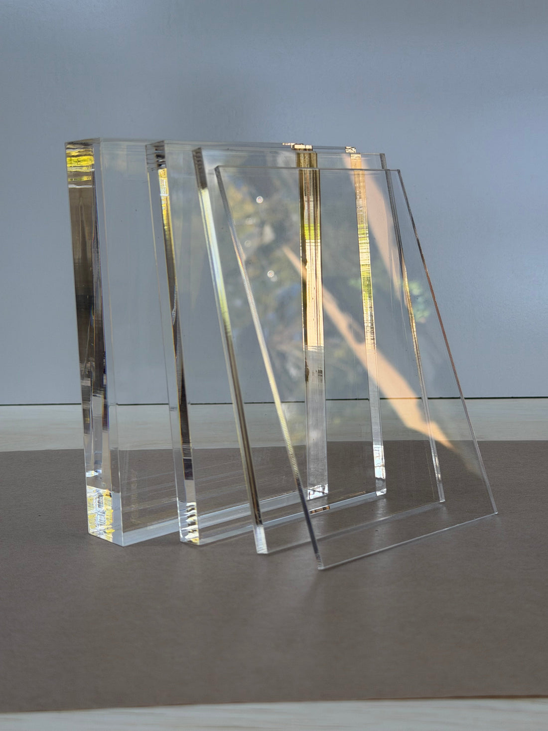 Clear cast acrylic in 1/8, 1/4, 1/2 and 1 inch thicknesses standing on edge