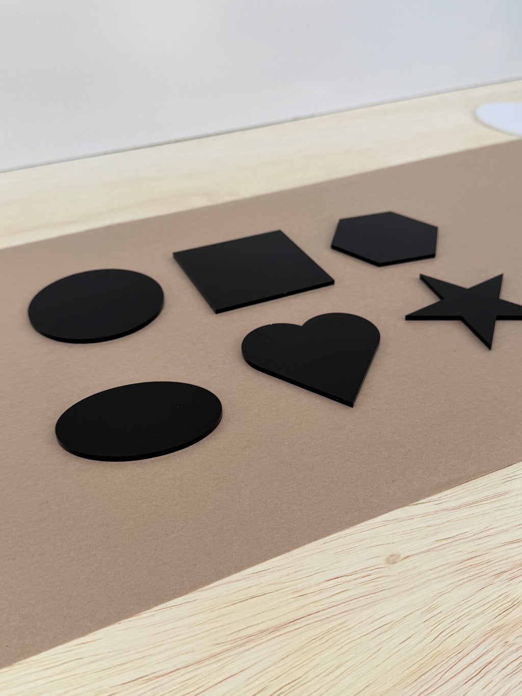 Black glossy acrylic UV printing blanks in six shapes shown at an angle