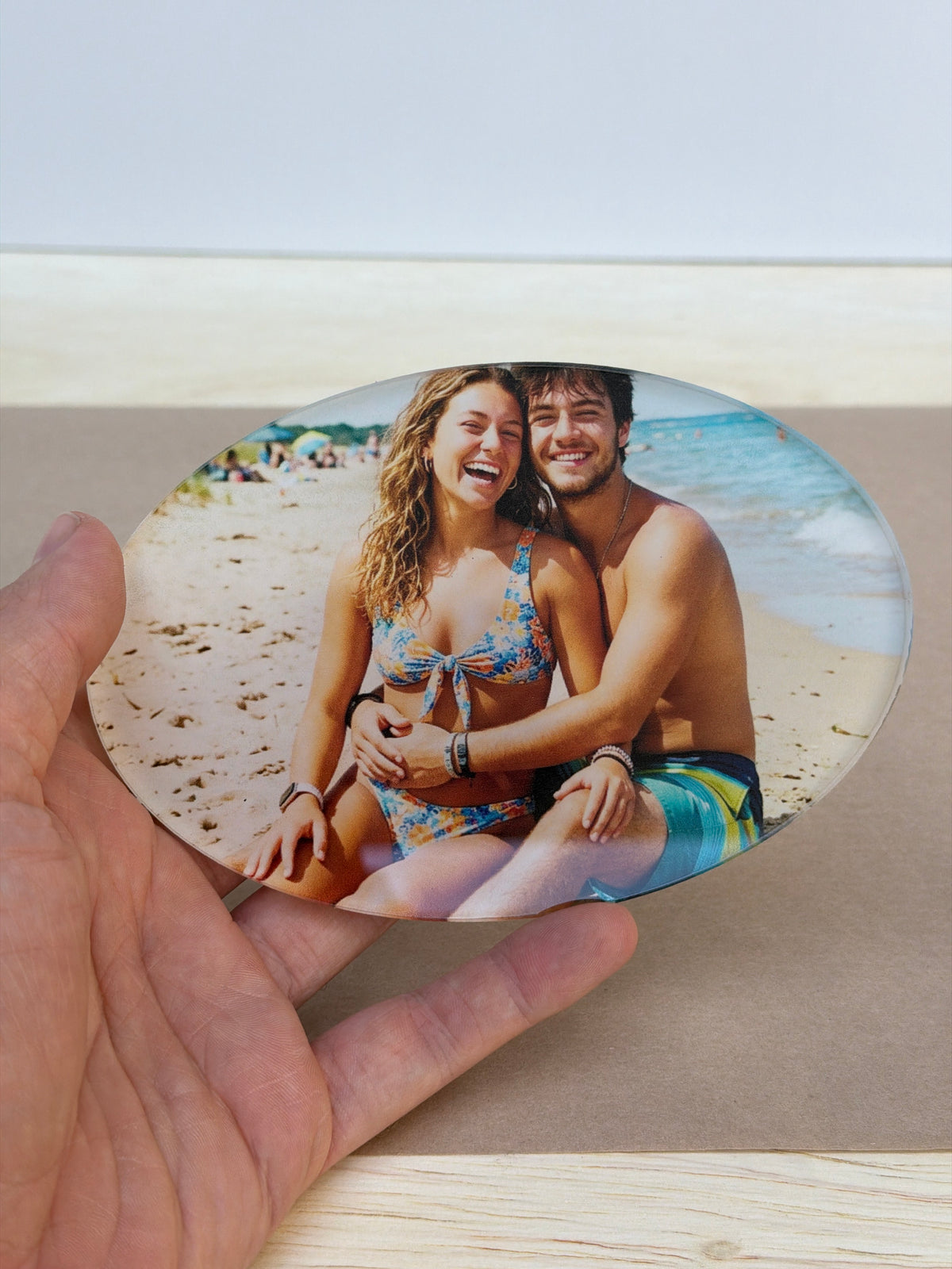 UV printed photo plaque on a 1/4 inch acrylic oval, held in hand
