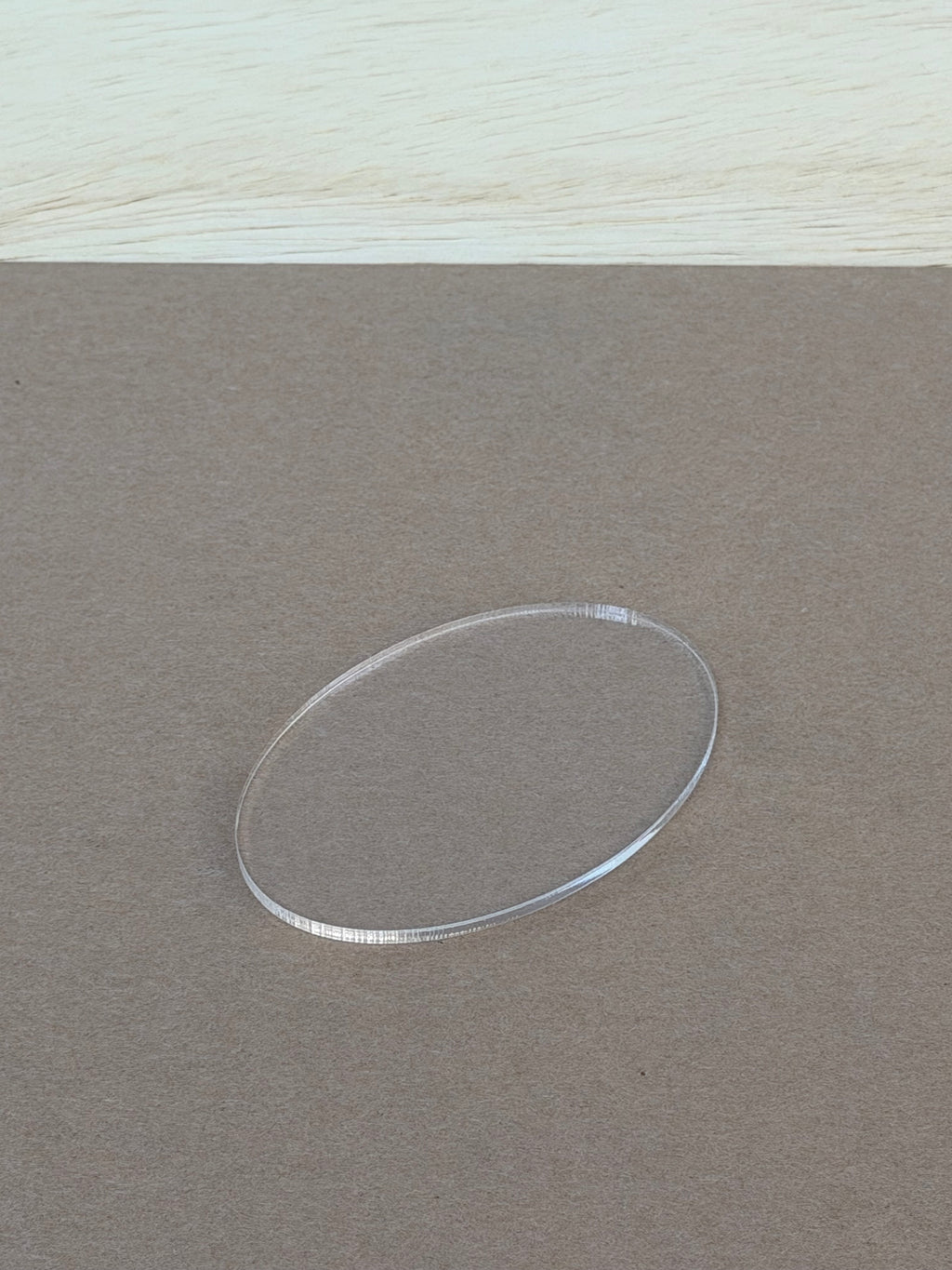 Polished laser cut edge on a 1/8 inch clear acrylic oval blank
