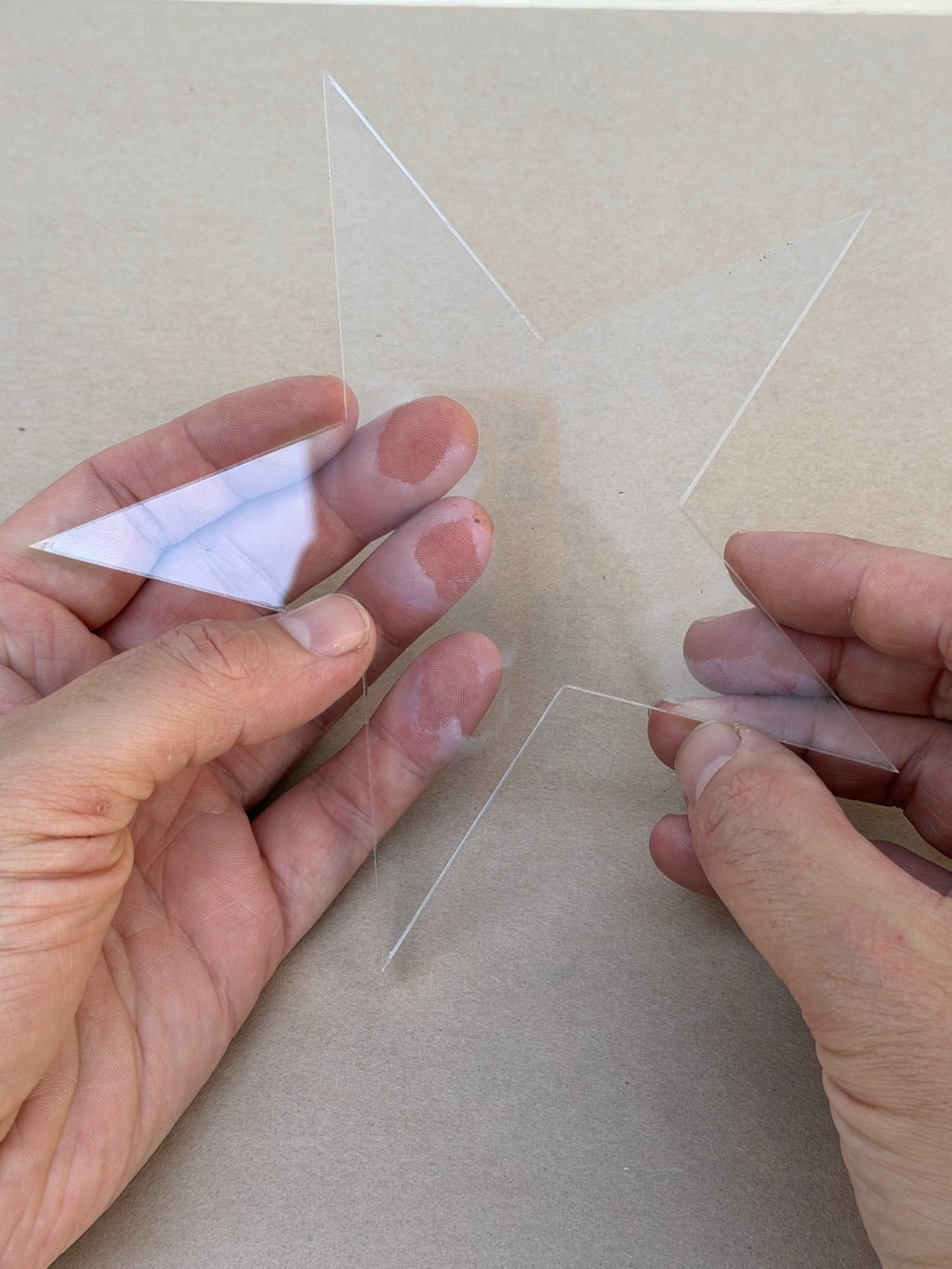 1/4 inch clear acrylic star blank held in hand to show size