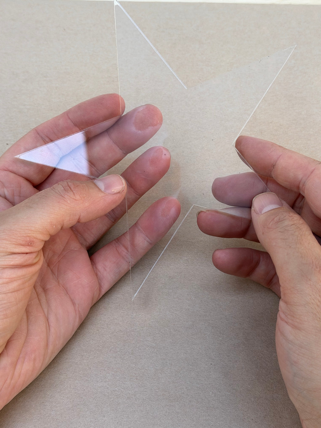 Peeling the protective film off a 1/4 inch acrylic star blank