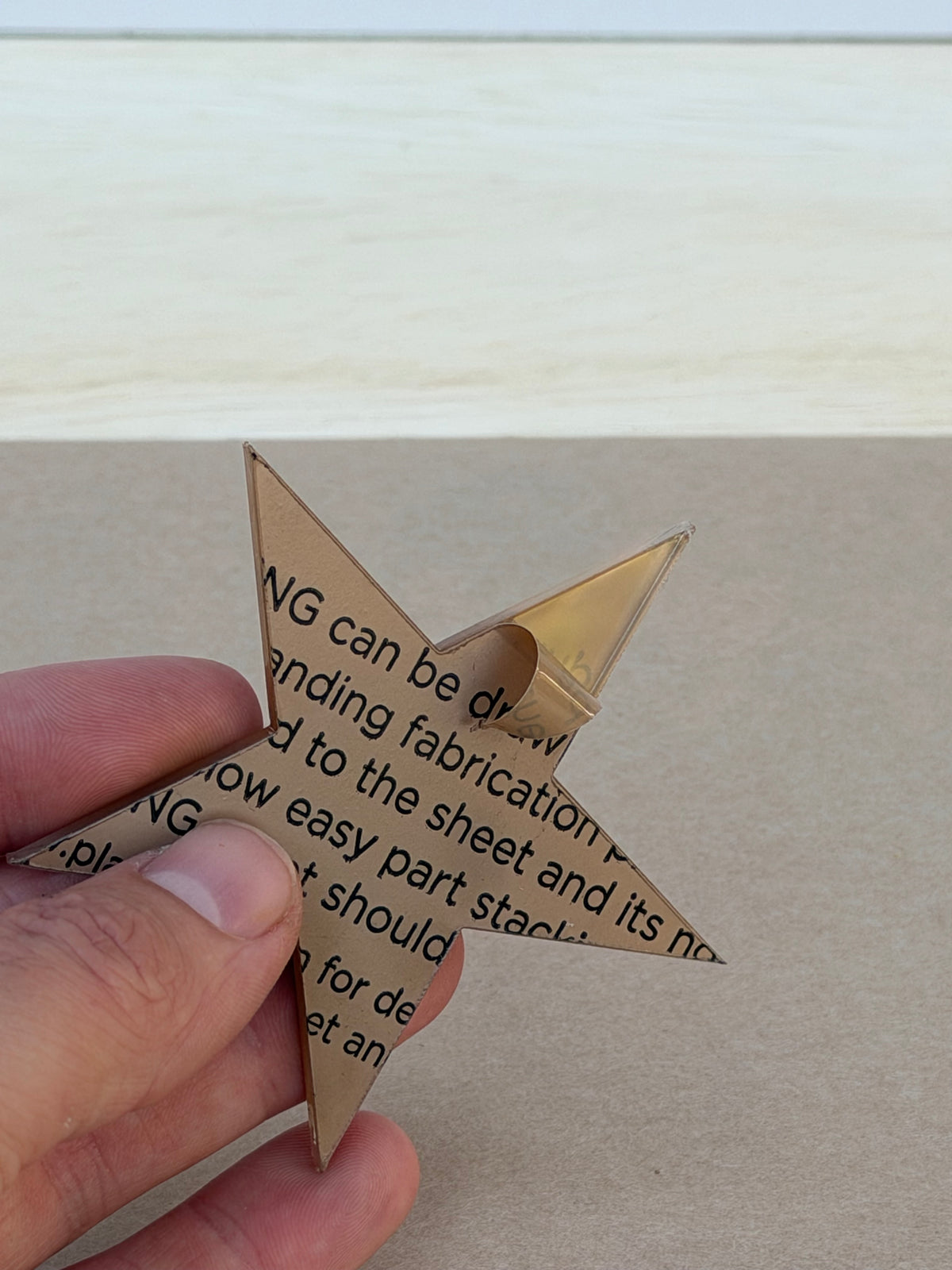 1/8 inch acrylic star blank with protective film, held in hand
